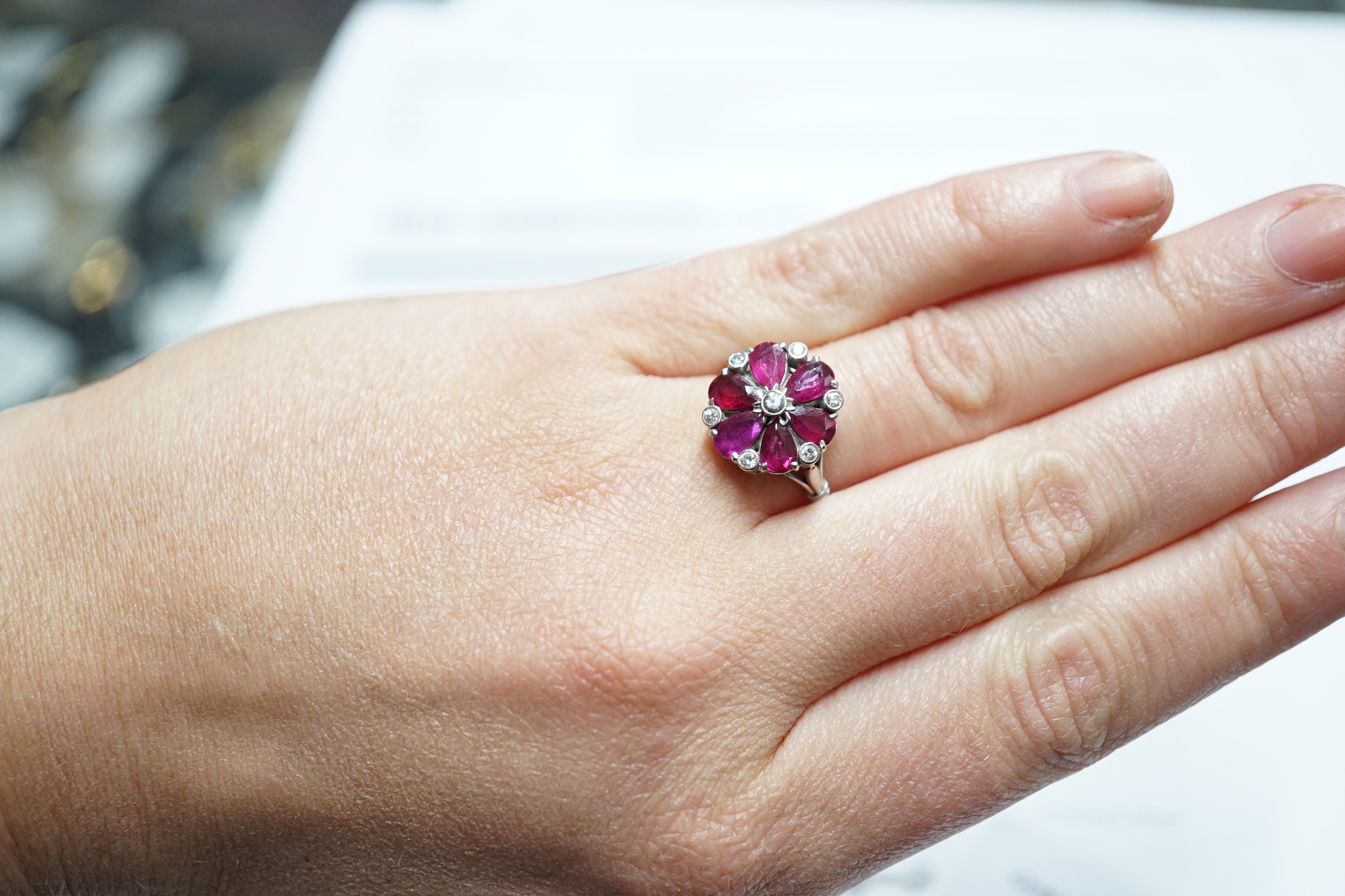 An 18ct & plat, pear cut ruby and diamond chip cluster set ring, size N/O, gross weight 4.8 grams.